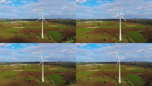 在高原多云的天空中，用于能源生产的强大风力涡轮机农场的鸟瞰图。为可持续发展提供清洁可再生能源。高清在线视频素材下载