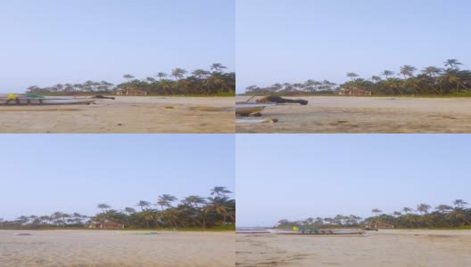 在海滩上向小岛走去，海滩对面是绿色的热带树木。蓝色的天空高清在线视频素材下载