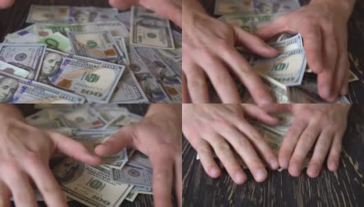 手在一张木桌上拉钞票，桌子的背景是钞票高清在线视频素材下载