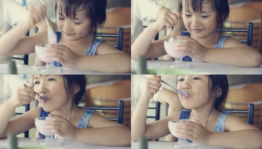 亚洲小孩在休息时间吃冰淇淋。高清在线视频素材下载