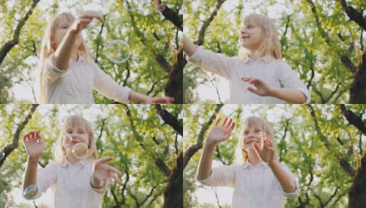 A cheerful blonde girl is playing with soap bubbles. Carefree happy childhood concept高清在线视频素材下载