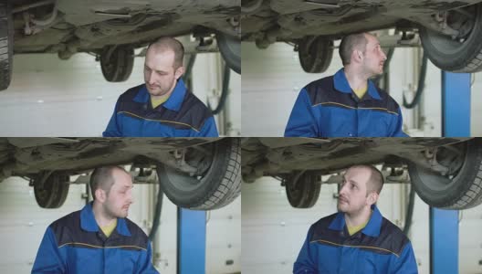 在汽车维修服务中，汽车修理工正在检查跨界车的汽车悬架高清在线视频素材下载