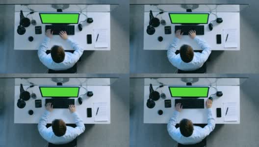 顶部视图勤奋的会计工作在他的办公桌上的一个绿色屏幕上的个人电脑。还在桌上签署了文件和手机。高清在线视频素材下载