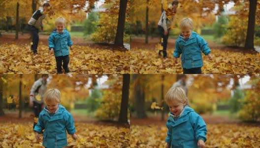 童年时光:少年和小男孩在公园里玩秋叶高清在线视频素材下载
