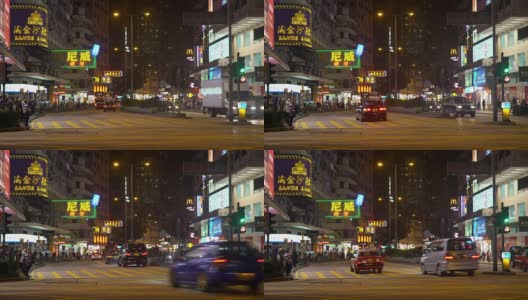 游客和当地居民晚上在香港市中心等待过一条繁忙的马路高清在线视频素材下载