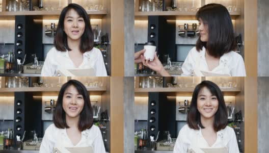 美丽的亚洲咖啡师与客户交谈高清在线视频素材下载