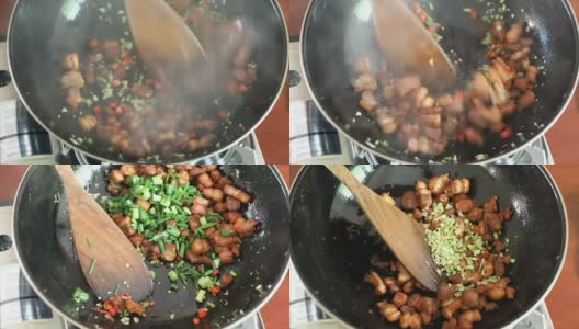用辣椒，大蒜和香草炒猪肉。亚洲辣菜，用黑色平底锅烹饪高清在线视频素材下载