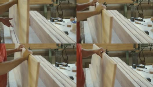 木匠在家具厂贴木板高清在线视频素材下载