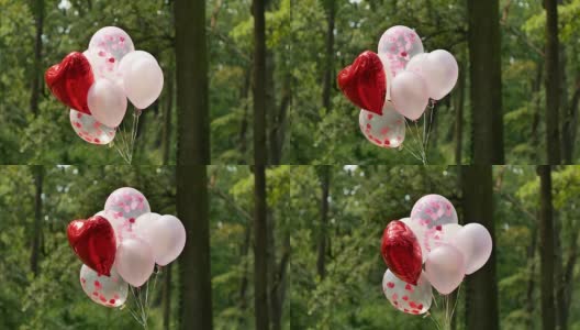 很多粉色的氦气球和一个大的红色心形气球高清在线视频素材下载