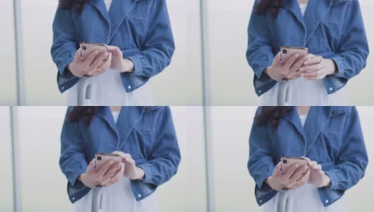 近距离女子在蓝色夹克使用移动终端站高清在线视频素材下载