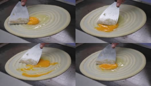 制作泰国煎饼夹鸡蛋的特写，泰国甜品街头小吃高清在线视频素材下载