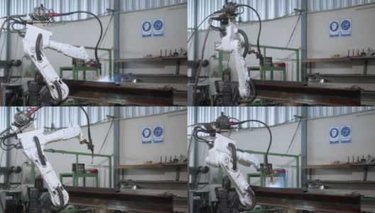 工业4.0概念现代自动化机器人焊接臂机床焊接金属管道和钢板与明亮的火花和烟雾在生产工厂车间的事实背景高清在线视频素材下载