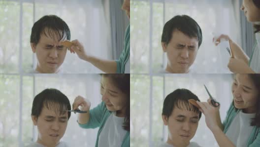一位亚洲妇女在家为丈夫理发。高清在线视频素材下载