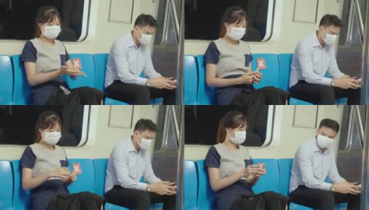 亚洲职业女性乘坐地铁时戴口罩预防新冠肺炎。喷洒酒精清洁双手。在冠状病毒疫情情况下，注意出行上班。社会距离高清在线视频素材下载