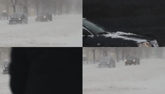 冬天。汽车在城市的雪道上行驶。慢动作降雪。交通状况不佳，暴风雪。有发生交通事故的危险。十字路口高清在线视频素材下载