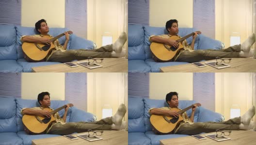 年轻人弹吉他，休息后放松高清在线视频素材下载