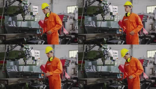 一个穿着橙色制服的男性技术员正在修理一台坏了的机器。高清在线视频素材下载