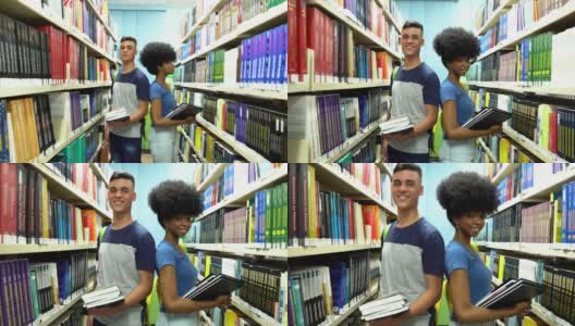 两个学生在图书馆拿着书的肖像高清在线视频素材下载