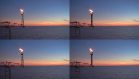 火炬燃烧的石油和天然气平台桥或海上平台以日出和海上美丽的云朵为油气行业的概念。高清在线视频素材下载
