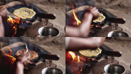 妇女在泥炉上做饭高清在线视频素材下载