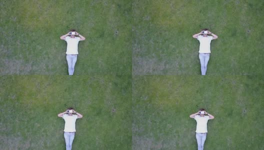 用VR眼镜在草地上降温高清在线视频素材下载