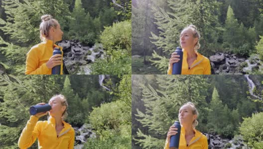 一个徒步旅行的女人从金属瓶子里喝新鲜的水。女性天然保湿。积极健康的生活方式。高清在线视频素材下载