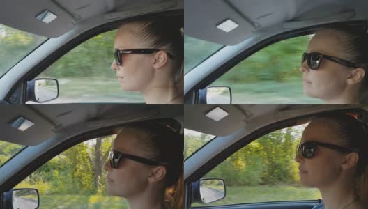 年轻漂亮的白人女子戴着太阳镜坐在车里。高清在线视频素材下载
