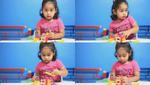 一个快乐的印度小女孩在玩积木高清在线视频素材下载