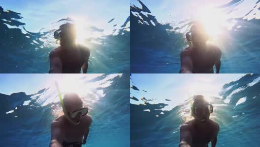 一个年轻人在潜水，阳光照耀着海面高清在线视频素材下载