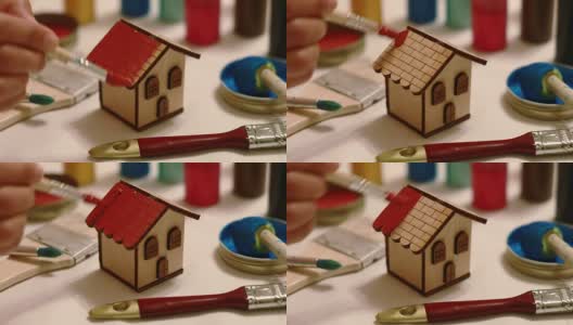 DIY:粉刷小木屋的屋顶高清在线视频素材下载