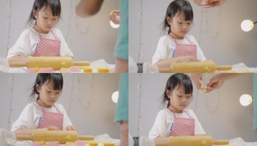 亚洲女孩使用饼干切割成型自制饼干庆祝圣诞节，生活方式的概念。高清在线视频素材下载