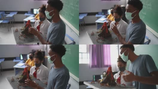学生在教室里用口罩做关于火山的演讲高清在线视频素材下载