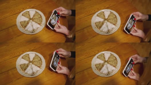 女孩用智能手机的相机拍下了蛋糕。高清在线视频素材下载