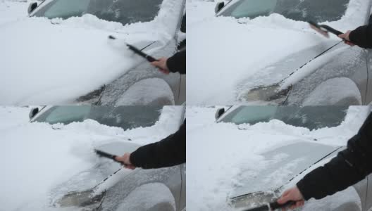 暴风雪过后，人们从车窗上刷下刚下的雪。在寒冷的冬天早晨，车主们的日常困难。汽车清洗窗户。冬天的季节。白色的雪。汽车护理。高清在线视频素材下载