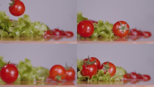 切菜板上的圣女果落在湿的长叶莴苣叶上。高清在线视频素材下载