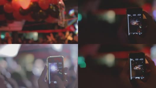 Woman's hand holding a smart phone during a concert高清在线视频素材下载