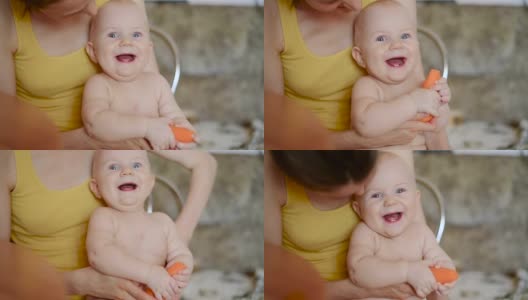 宝宝微笑着坐在妈妈的膝盖上，近处高清在线视频素材下载