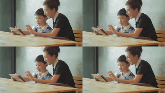 亚洲母亲和儿子使用平板电脑高清在线视频素材下载