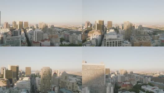 在明亮的阳光照耀下，在市中心的建筑物上飞翔。又长又直的街道和多层的办公或公寓结构。南非开普敦高清在线视频素材下载