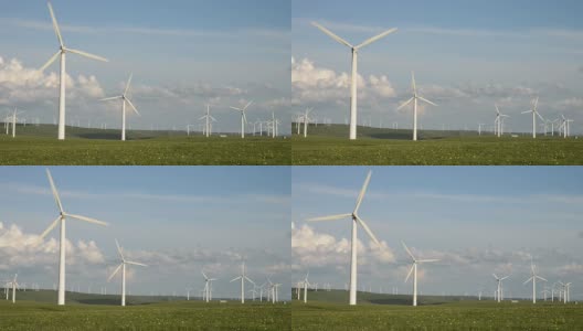 蓝天下旋转的风力涡轮机和草地，实时。高清在线视频素材下载