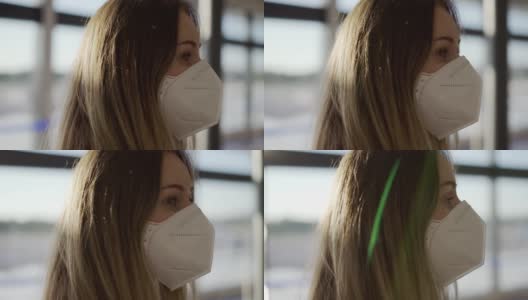 一个带着防护面具，有点困惑的女人站在机场高清在线视频素材下载
