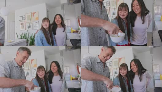 一家人在厨房里一起做早餐，女儿患有唐氏综合症高清在线视频素材下载