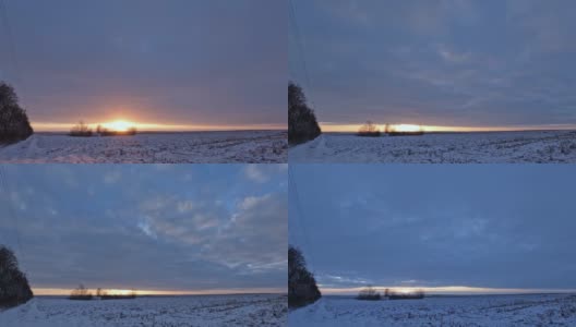 乡村田野上的冬季日出景观，时间流逝。厚厚的云层飞了过去，有一会儿太阳的光线出现了，它遮住了厚厚的云层。高清在线视频素材下载