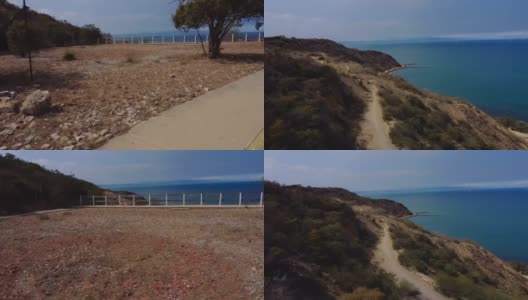 一架无人机在光天化日之下穿过围栏，拍摄海洋景观的视频高清在线视频素材下载