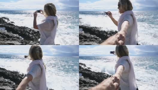 男人帮女人拍照，海面上高清在线视频素材下载