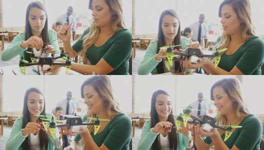 两个漂亮的西班牙少女在STEM学校合作创造机器人高清在线视频素材下载