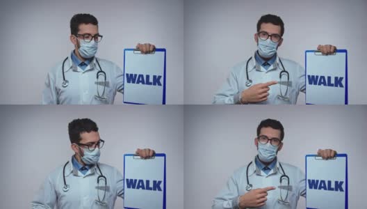 身穿白大褂、听诊器的医生展示了带处方单和WALK字样的纸架。医生建议高清在线视频素材下载