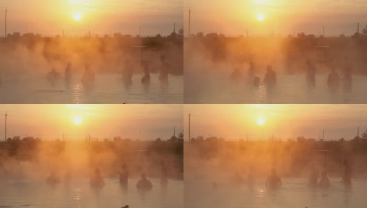 温泉在日出，人们在游泳高清在线视频素材下载