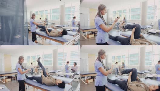 自信的女性理疗师协助男性患者进行腿部锻炼高清在线视频素材下载