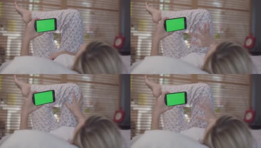 女人在床上用手机，肩膀看，视频聊天。高清在线视频素材下载